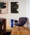 Planta Chair by Sancal in purple with arms by a blue side table – In Dubai by WSPR
