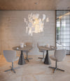 Planta Chair by Sancal in grey on four-star bases around a café table – In Dubai by WSPR