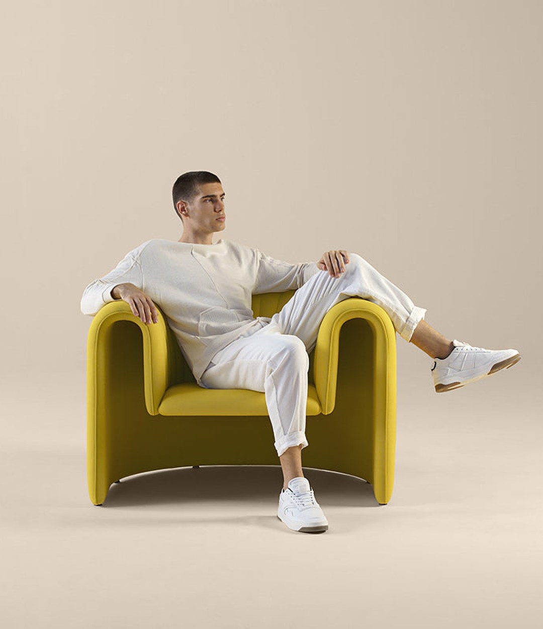 Remnant Armchair by Sancal in yellow with a man seated – In Dubai by WSPR
