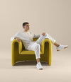 Remnant Armchair by Sancal in yellow with a man seated – In Dubai by WSPR