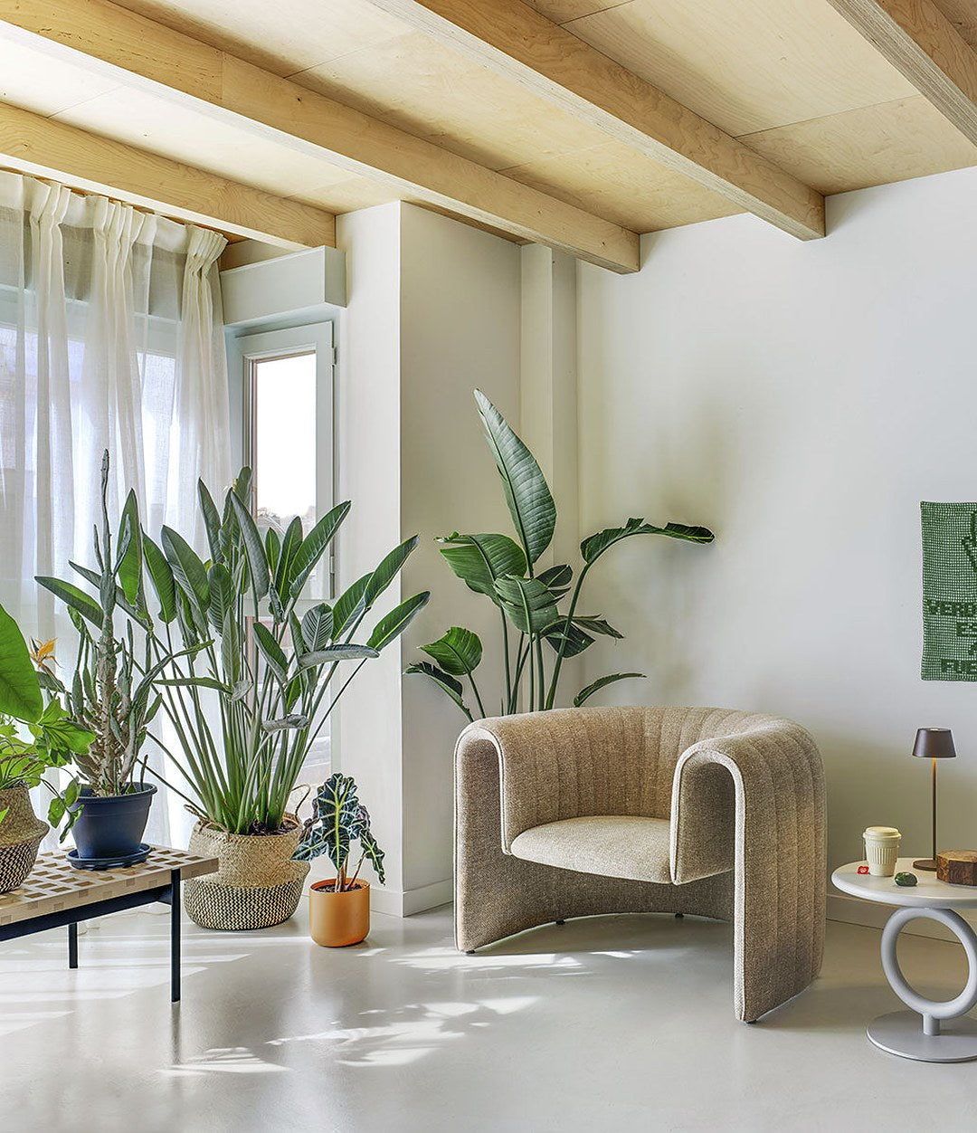 Remnant Armchair by Sancal in beige among plants – In Dubai by WSPR