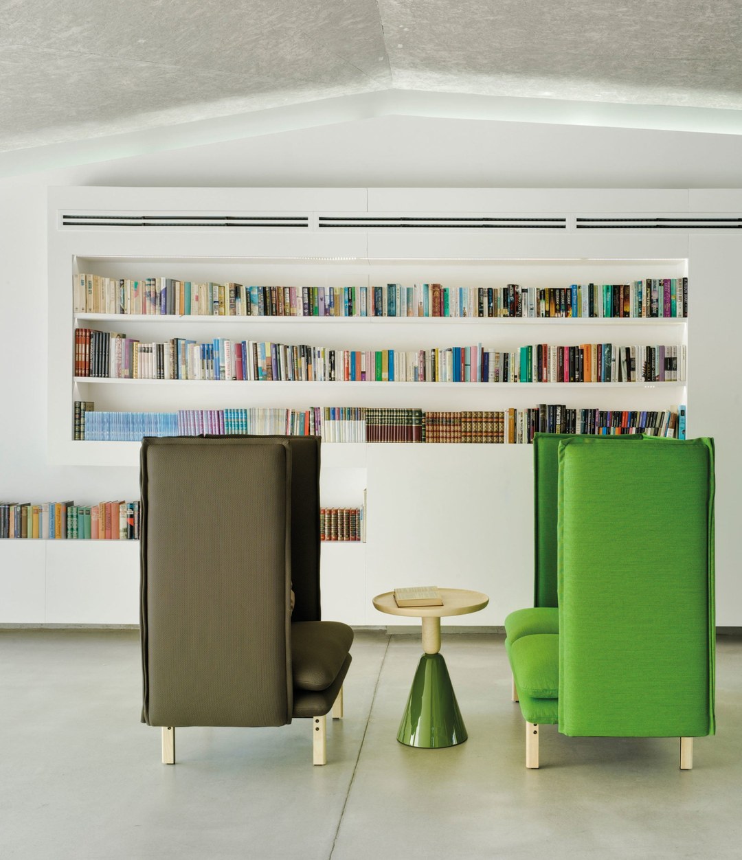 Rew Room by Sancal armchairs in green facing each other in a library – In Dubai by WSPR