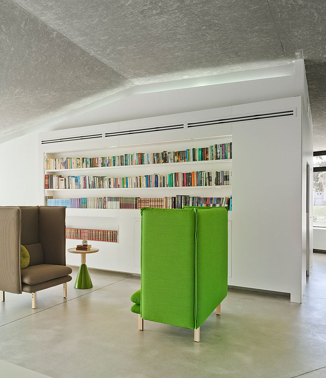 Rew Room by Sancal armchairs in green in a library, wide view – In Dubai by WSPR