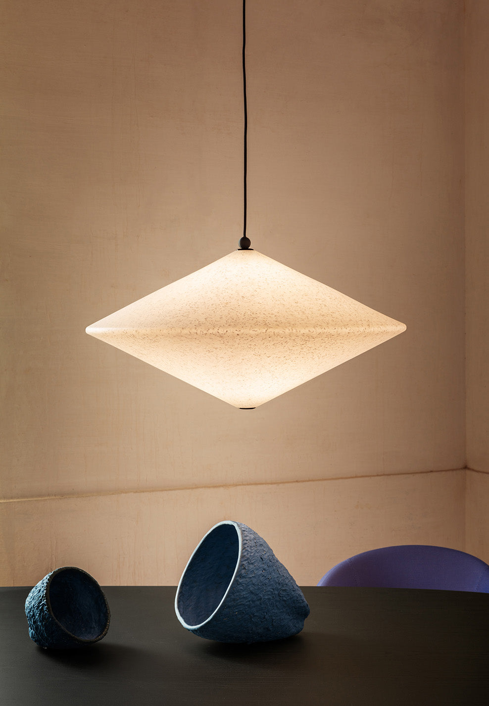 Rificolona Pendant by Miniforms, tilted shade over a dark table – In Dubai by WSPR