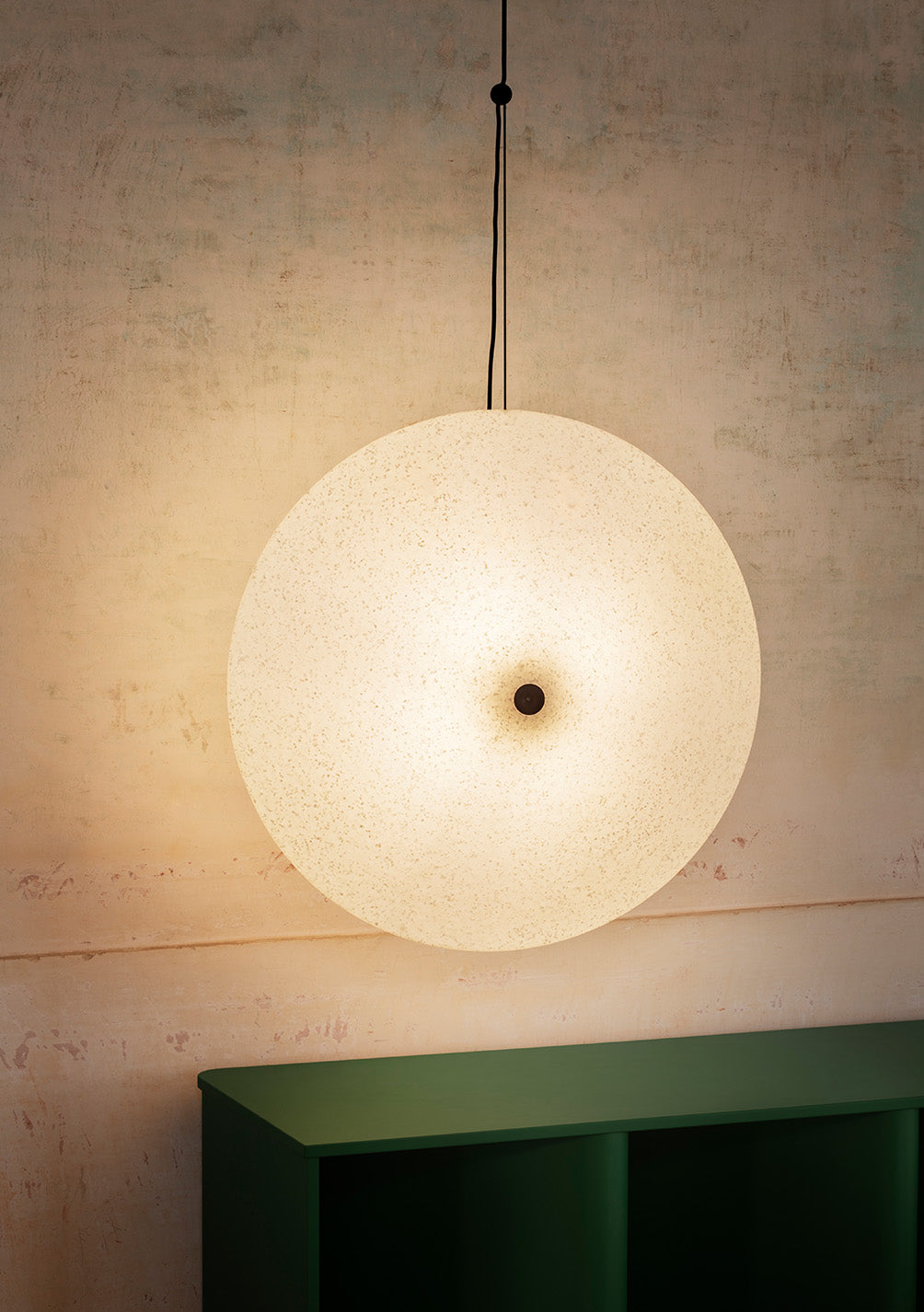 Rificolona Pendant by Miniforms, round shade close-up above a green console – In Dubai by WSPR