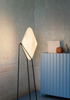 Rificolona Floor Lamp by Miniforms in White Moon, tilted shade on a black tripod against a pale wall – In Dubai by WSPR