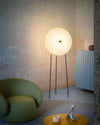 Rificolona Floor Lamp by Miniforms styled in a stone-walled room, in White Moon with a green armchair – In Dubai by WSPR