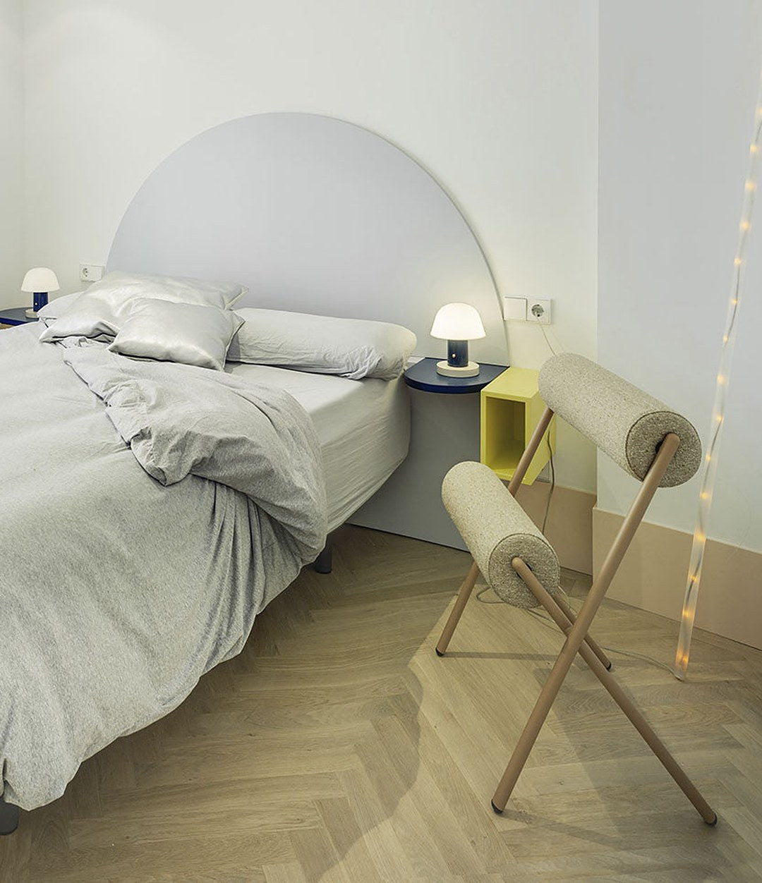 Roll Chair by Sancal in cream by a bed – In Dubai by WSPR