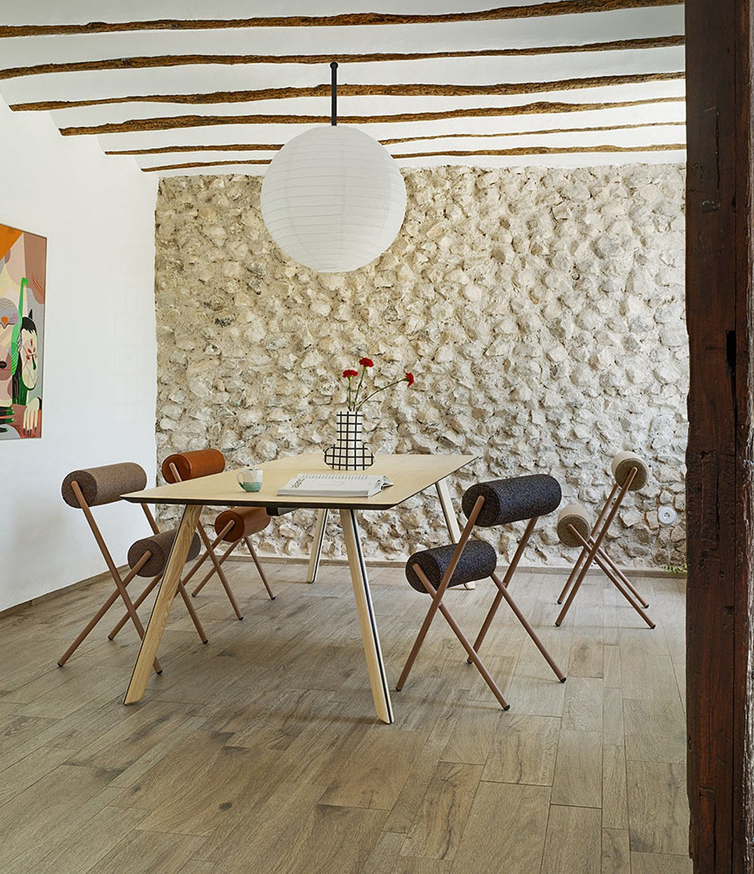 Roll Chair by Sancal around a wooden table in a stone-walled room – In Dubai by WSPR