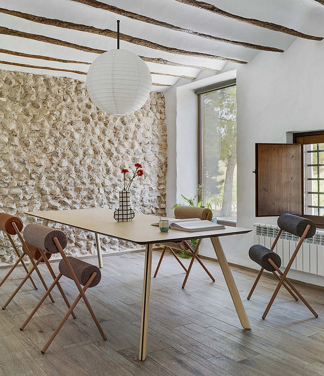 Roll Chair by Sancal around a wooden table, wide view – In Dubai by WSPR
