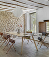 Roll Chair by Sancal around a wooden table, wide view – In Dubai by WSPR