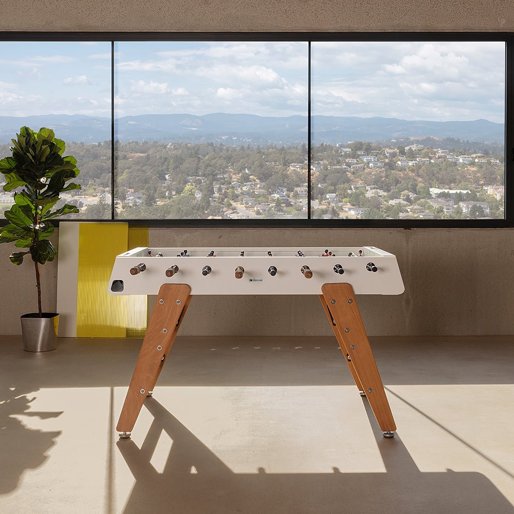 RS3 Foosball Table by RS Barcelona with iroko wood legs in Traffic White in a styled interior – In Dubai by WSPR