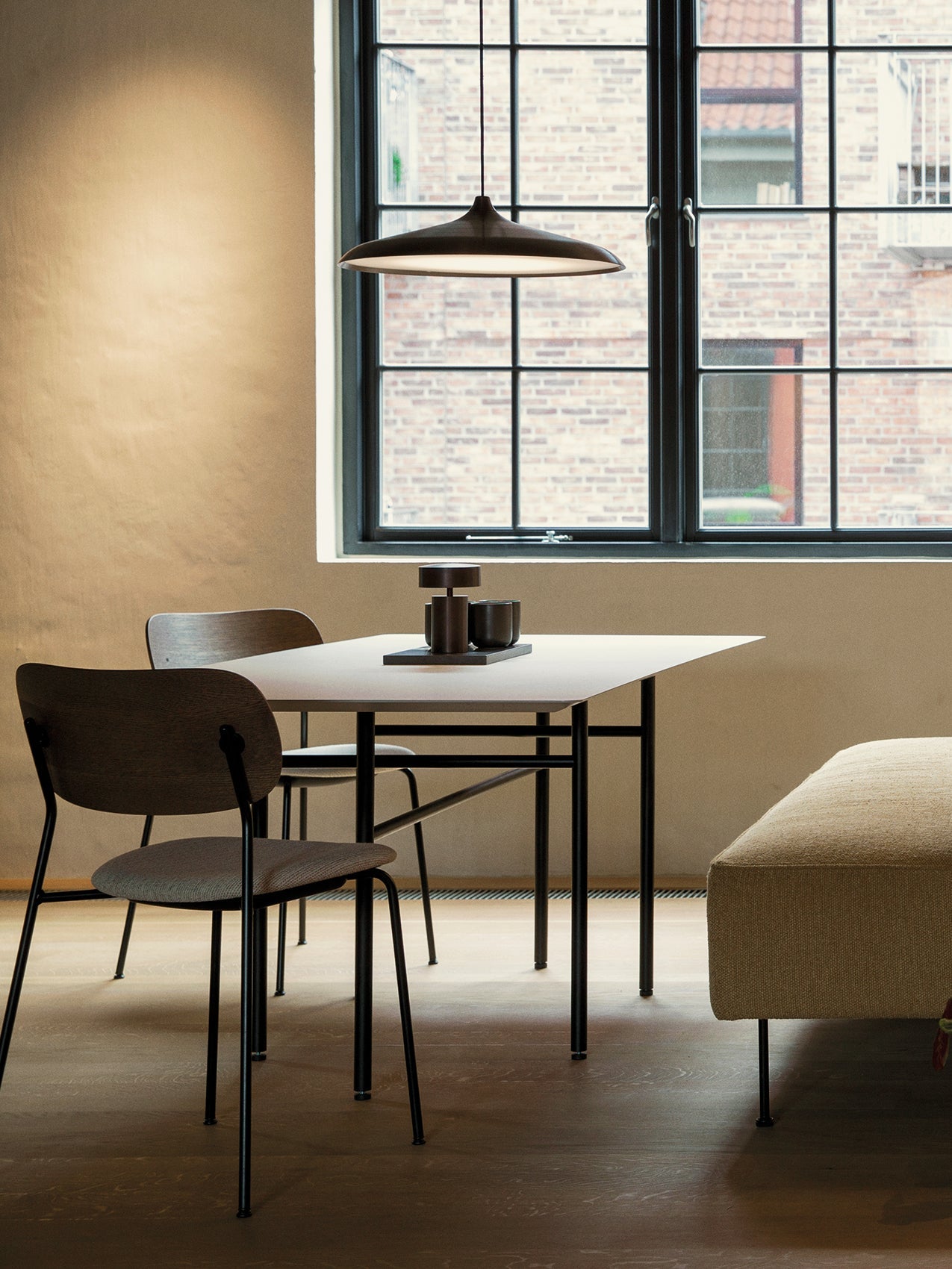 Circular Pendant by Audo styled above a dining table by a large window – In Dubai by WSPR