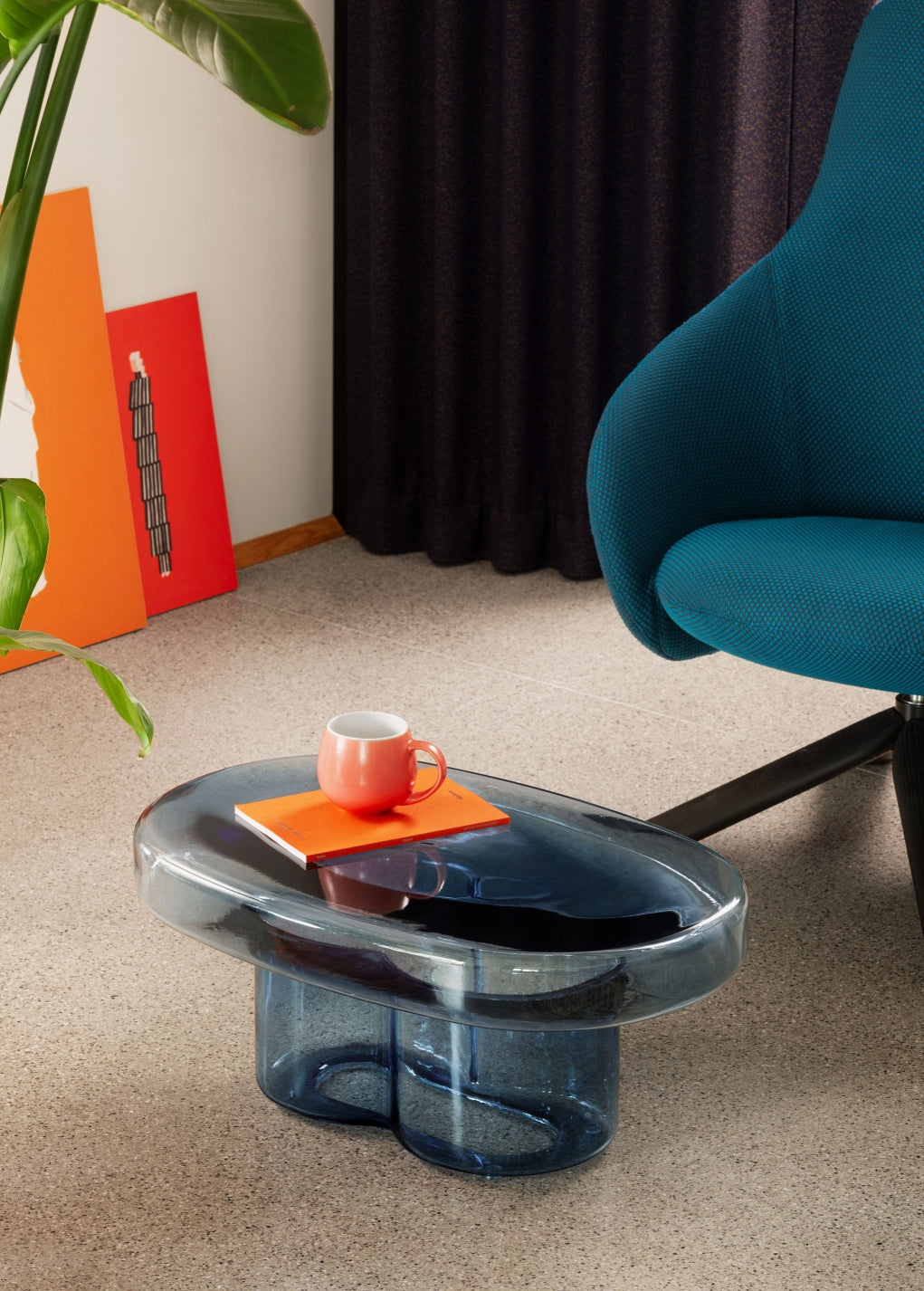 Soda Oval Coffee Table by Miniforms styled in blue blown glass beside a teal armchair – In Dubai by WSPR