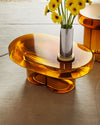 Soda Oval Coffee Table by Miniforms styled in amber blown glass with a vase of yellow flowers – In Dubai by WSPR