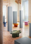 Soda Oval Coffee Table by Miniforms styled in a group of coloured blown glass tables in a hall with grey columns – In Dubai by WSPR