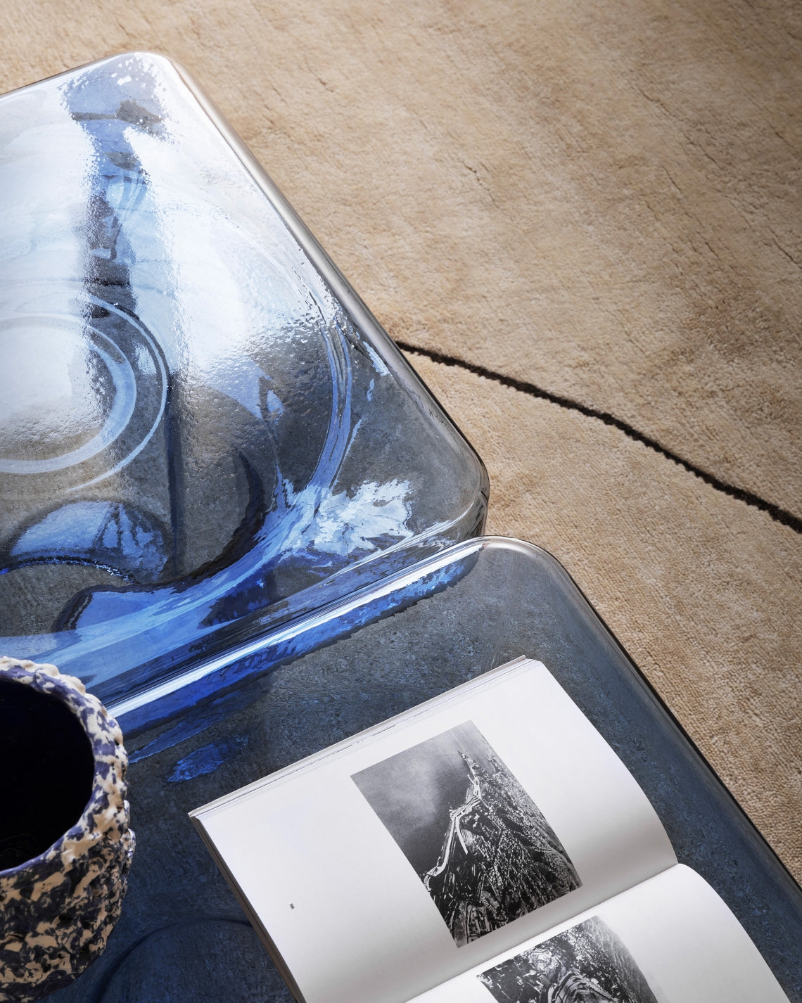 Soda SQ Coffee Table by Miniforms, close-up of blue blown glass with an open book – In Dubai by WSPR