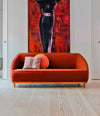 Sumo Sofa by Sancal in rust beneath a large painting – In Dubai by WSPR
