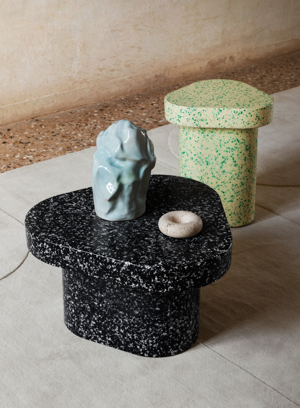Superpop Coffee Table by Miniforms styled as a side table with sculptural objects on a concrete floor – In Dubai by WSPR