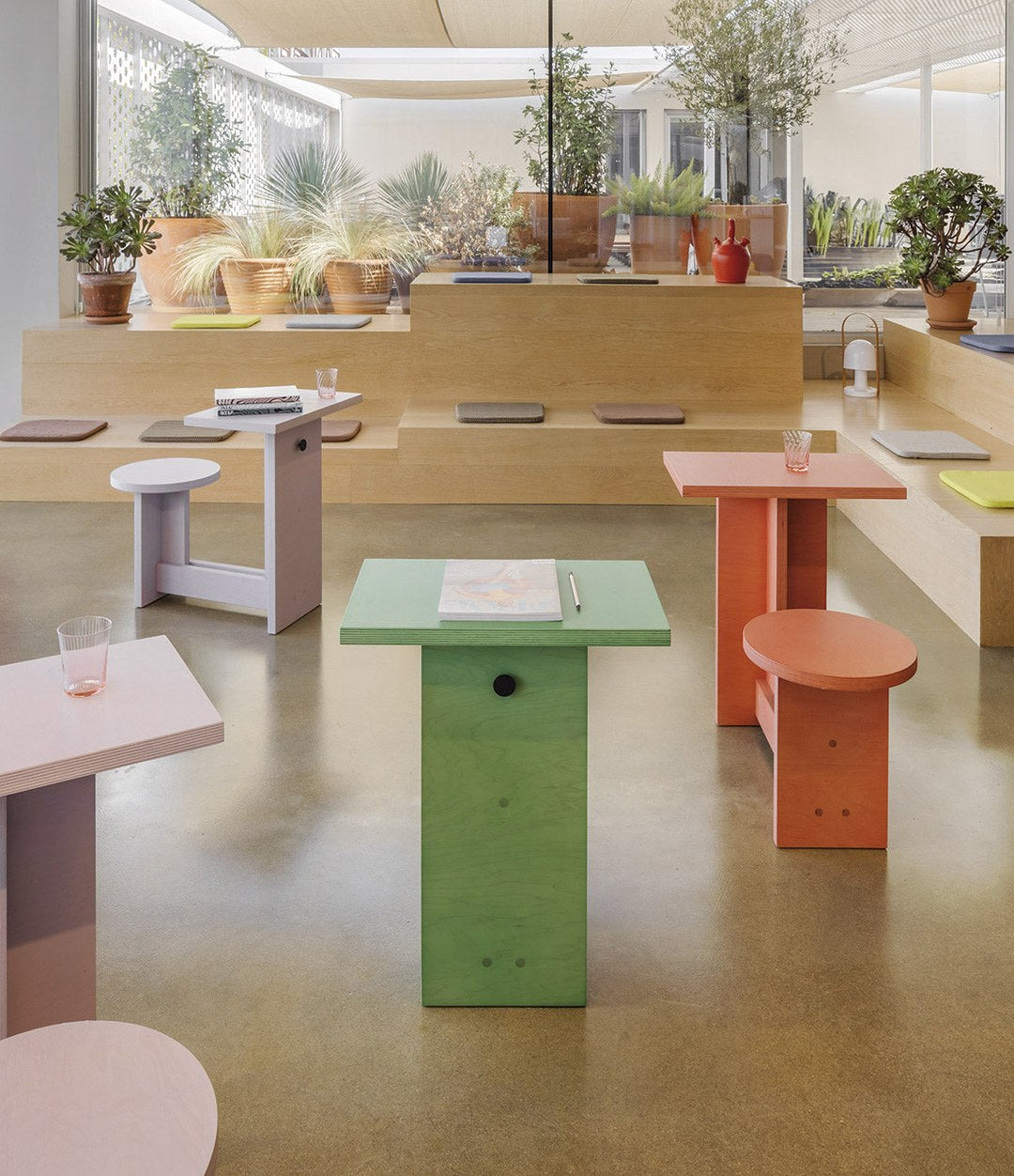 Suricata Desk by Sancal in green and orange in a café – In Dubai by WSPR