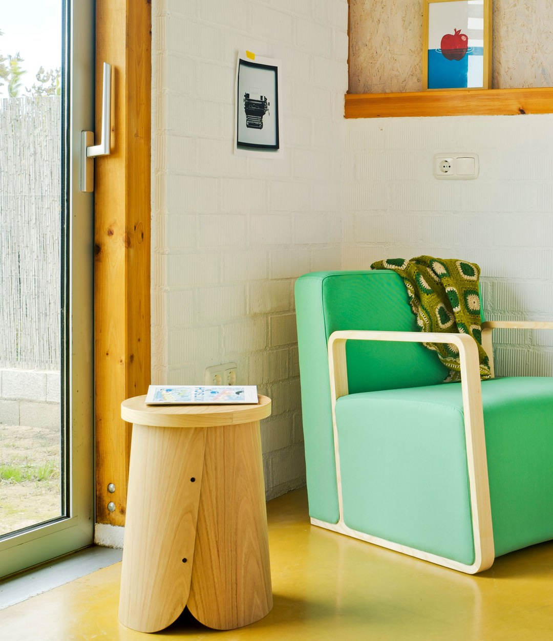 Tab Stool by Sancal by a green armchair – In Dubai by WSPR