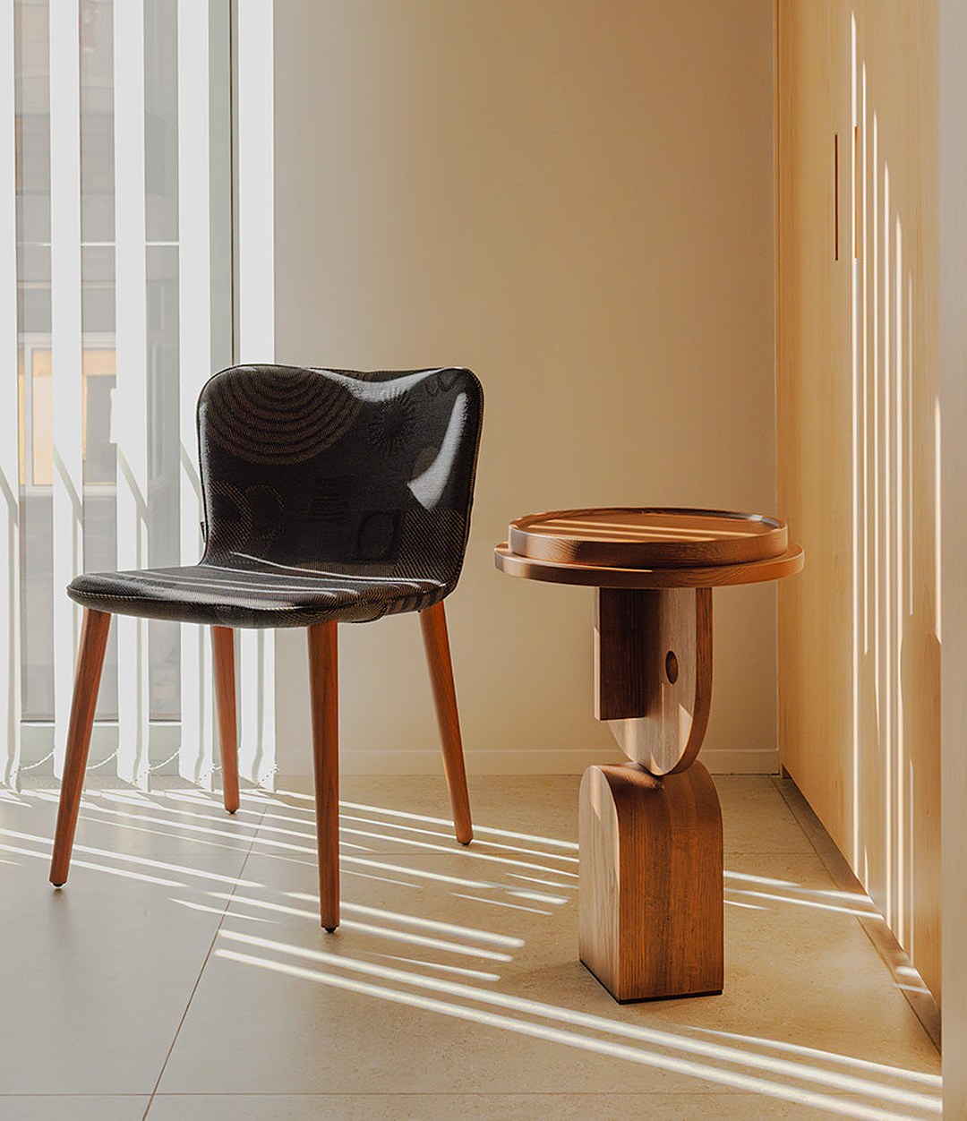 Tea Chair by Sancal in dark brown by a side table – In Dubai by WSPR