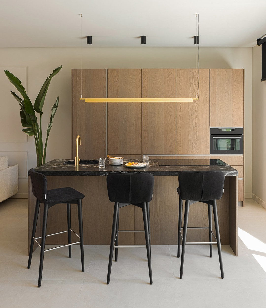 Tea Stool by Sancal in black at a dark island – In Dubai by WSPR