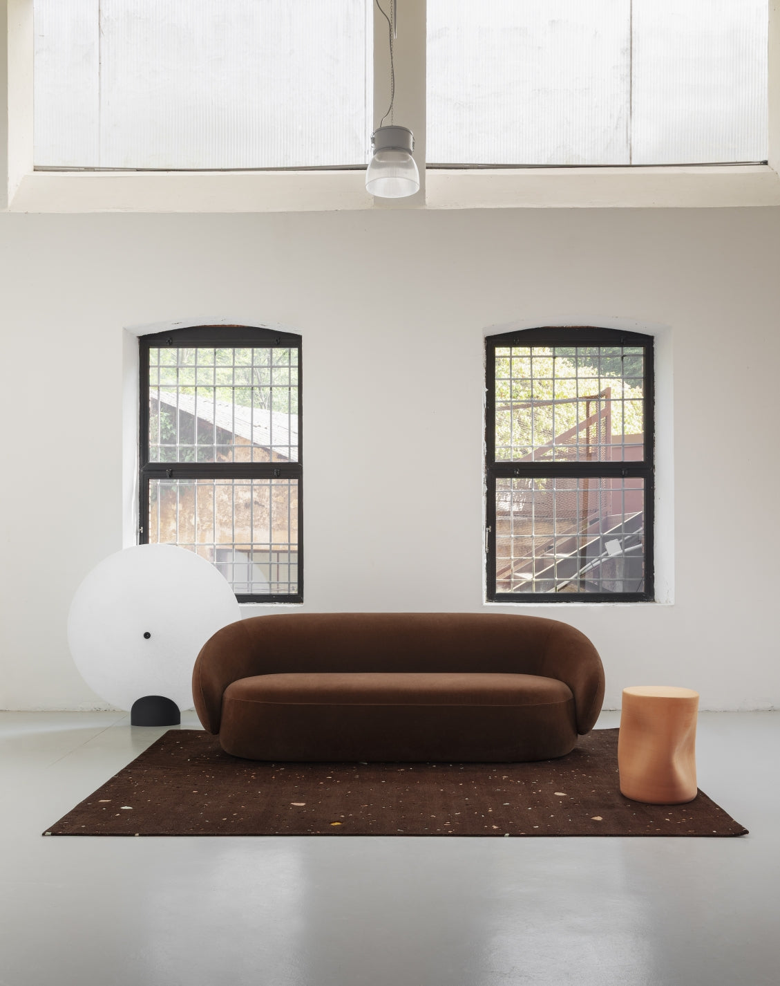 Toblo Coffee Table by Miniforms styled beside a brown curved sofa in a loft-style room with arched windows – In Dubai by WSPR