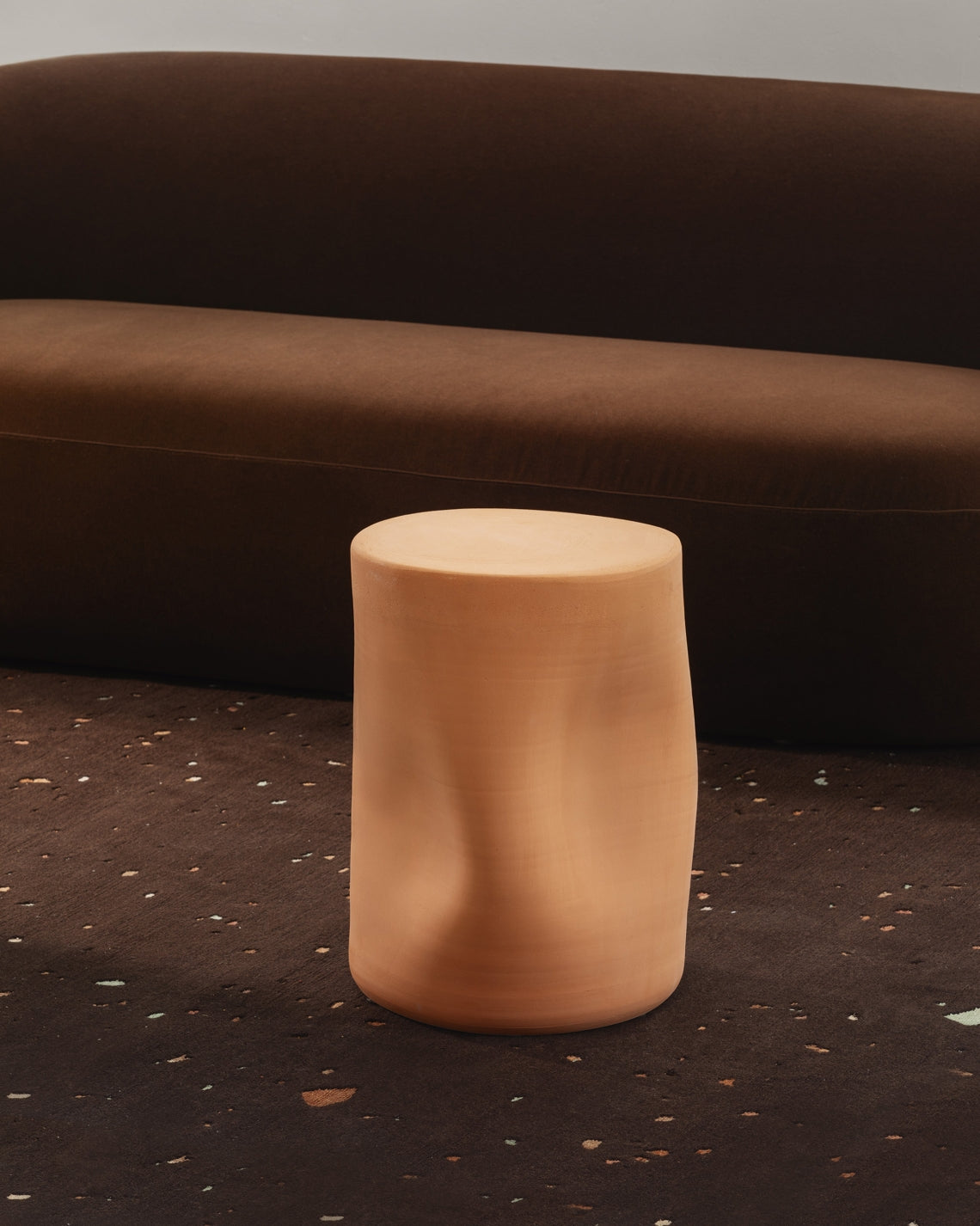 Toblo Coffee Table by Miniforms in natural baked clay, styled in front of a brown curved sofa – In Dubai by WSPR