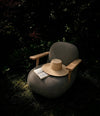 Toe Chair with Armrests by 101 Copenhagen in Teak / Stone Gray in a styled interior – In Dubai by WSPR