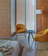 Tonella Lounge Chair by Sancal in mustard in a brick room – In Dubai by WSPR