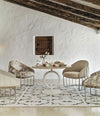 Tonella Lounge Chair by Sancal in patterned fabric around a dining table – In Dubai by WSPR