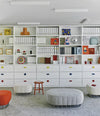 Tonella Pouf by Sancal in grey and red in front of shelving – In Dubai by WSPR
