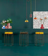 Tonella Stool by Sancal in yellow at a green counter – In Dubai by WSPR
