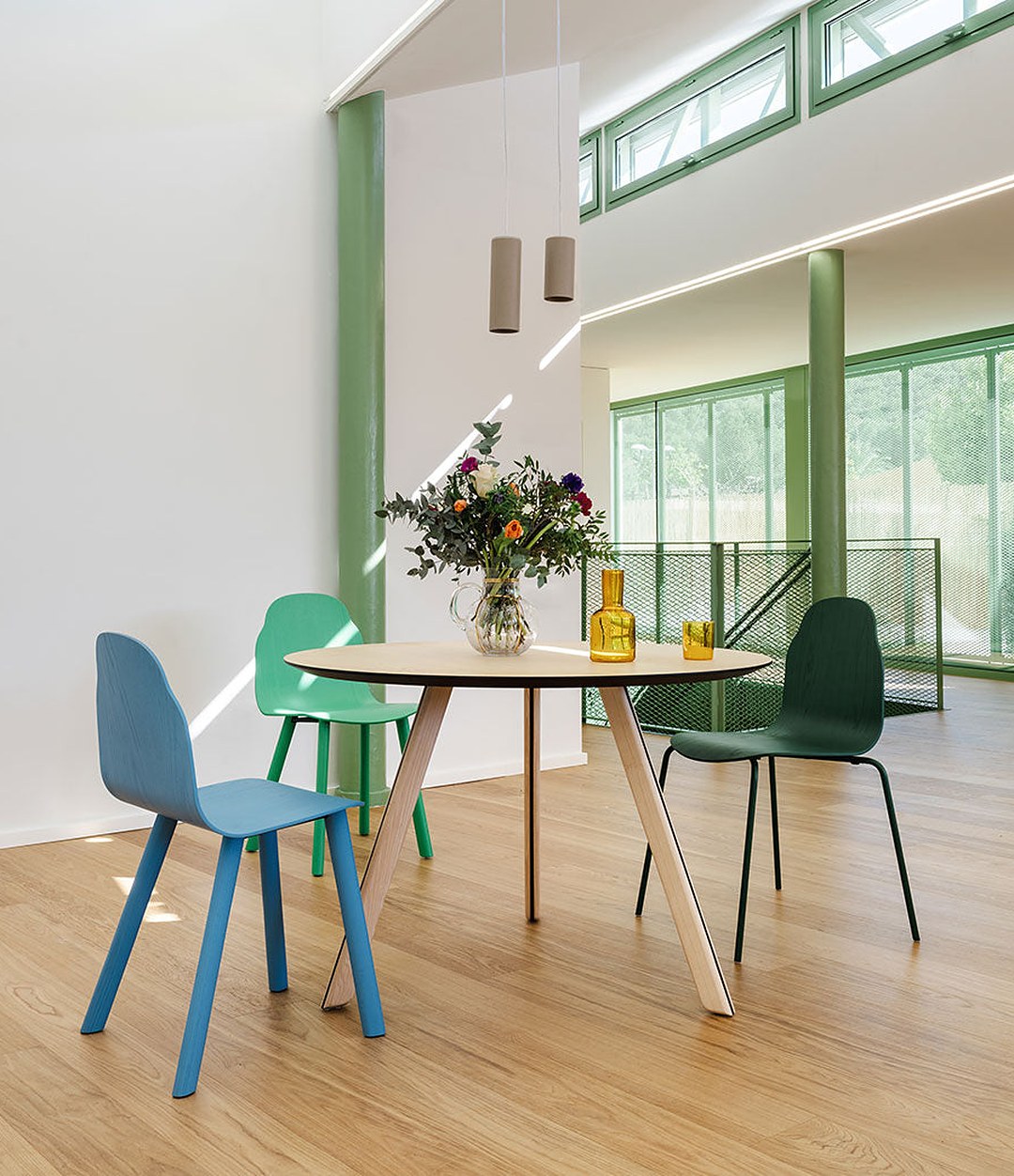 Tortuga Dining Table by Sancal round in natural ash with coloured chairs – In Dubai by WSPR