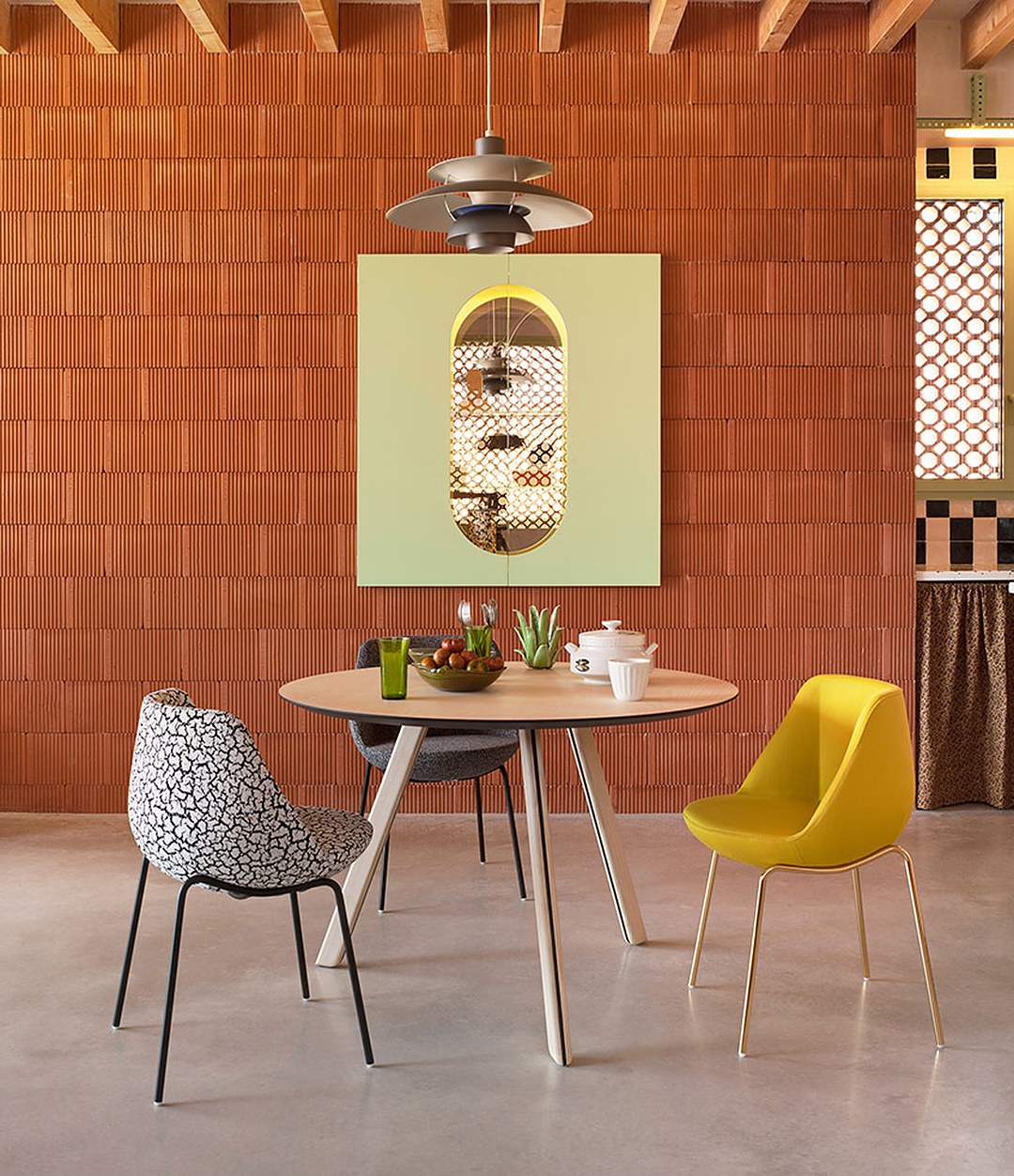 Tortuga Dining Table by Sancal round in natural ash against a brick wall – In Dubai by WSPR