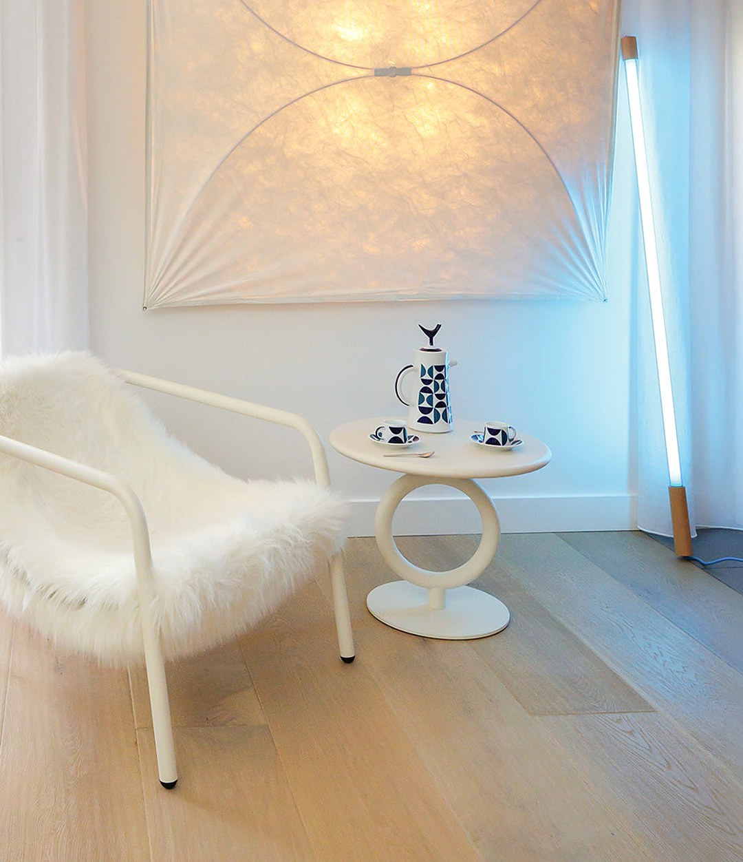 Totem Side Table by Sancal in white beside a sheepskin chair – In Dubai by WSPR