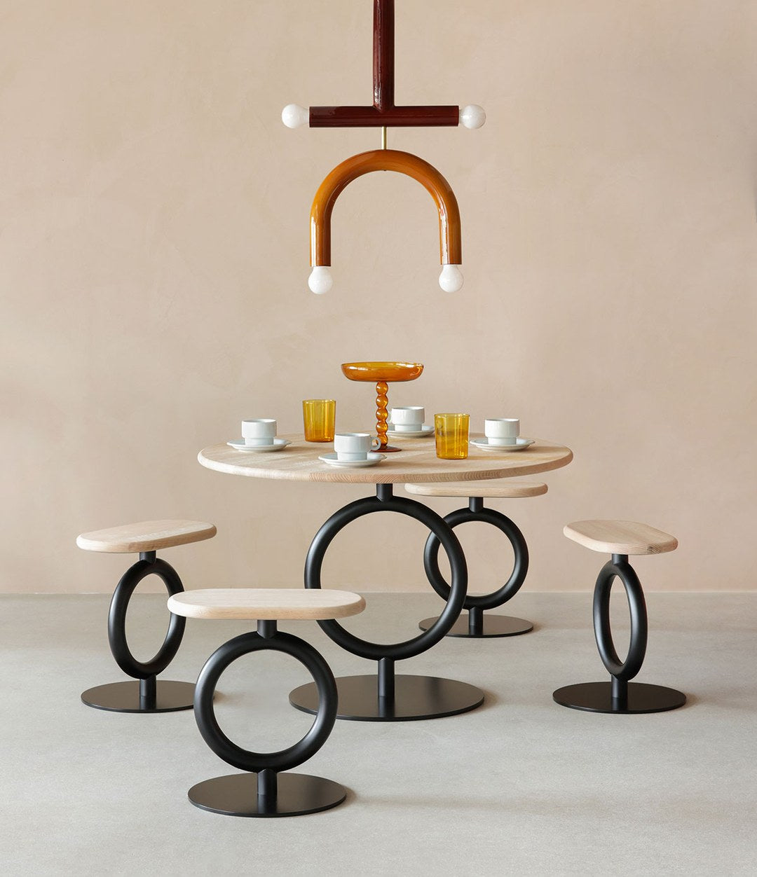 Totem Stool by Sancal low stools in black around a table – In Dubai by WSPR