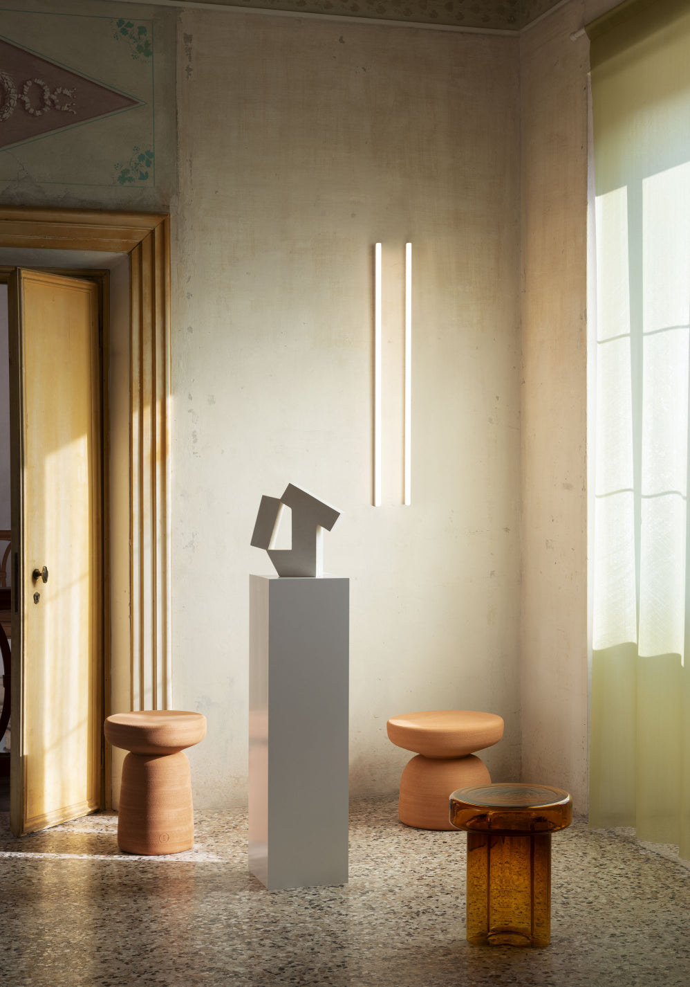 Tototò Coffee Table by Miniforms in natural terracotta, styled in a room beside a plinth and sculpture – In Dubai by WSPR