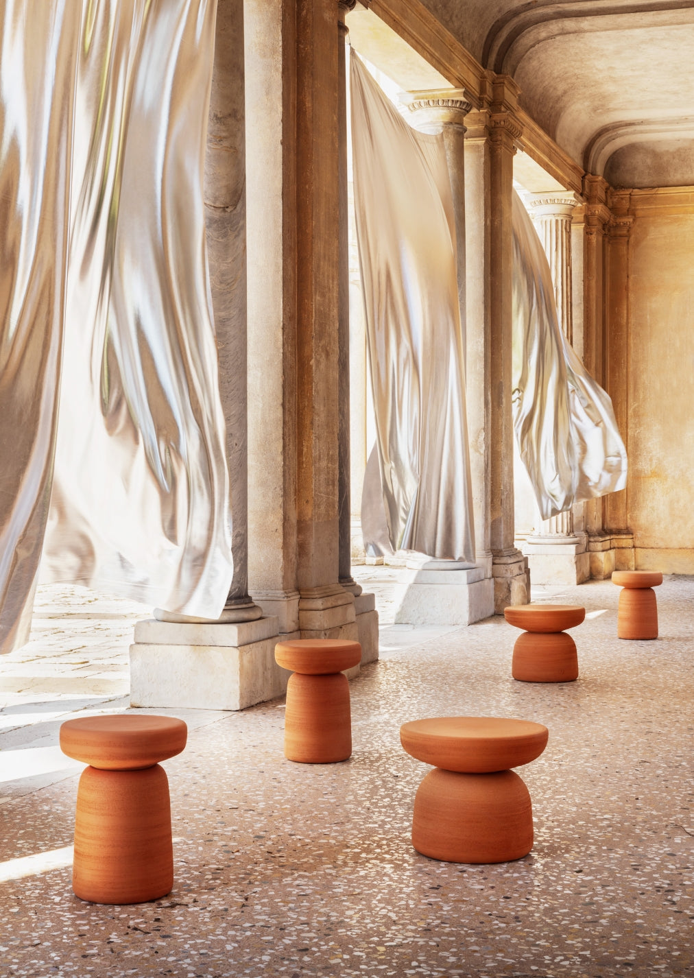 Tototò Coffee Table by Miniforms in natural terracotta, grouped in a hall with flowing curtains – In Dubai by WSPR