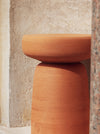 Tototò Coffee Table by Miniforms in natural terracotta, side detail against a stone wall – In Dubai by WSPR