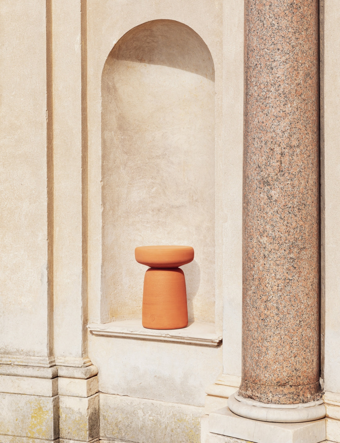 Tototò Coffee Table by Miniforms in natural terracotta, set in a stone alcove – In Dubai by WSPR