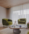 Vesper Coffee Table by Sancal in brown between green armchairs – In Dubai by WSPR