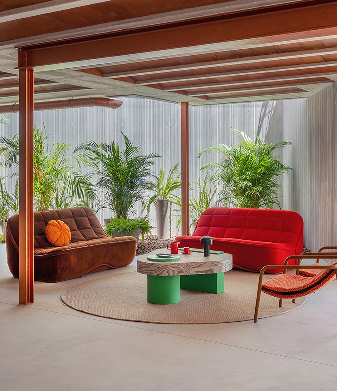 Vibe Sofa by Sancal in brown and red in a lounge with palms – In Dubai by WSPR