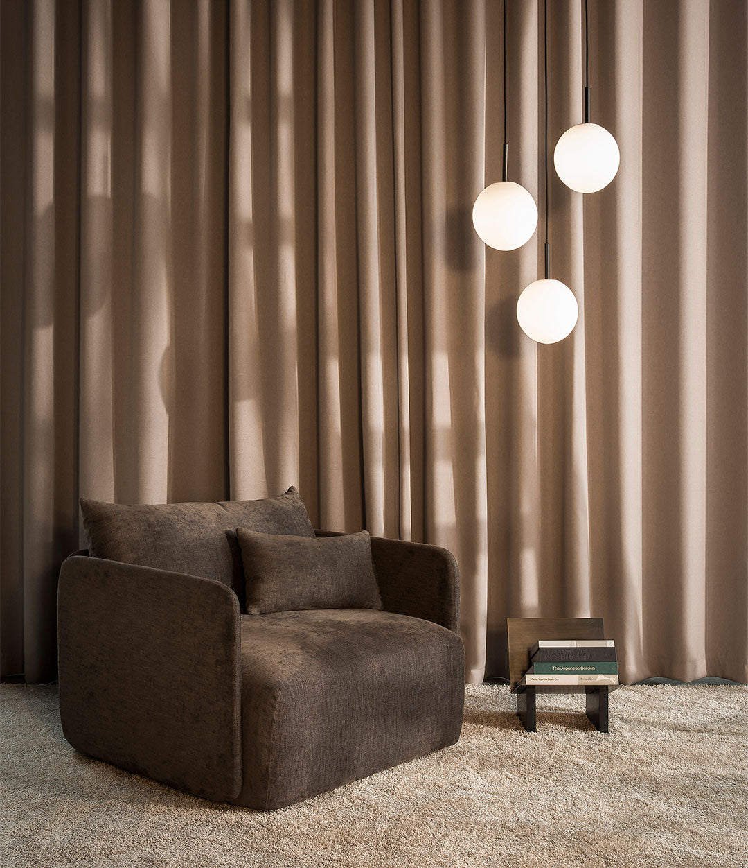 Offset lounge chair in a softly lit room with curtains
